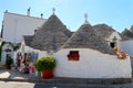 The traditional Trulli houses in the street of Alberobello city, Italy, Apulia region, with typical souvenir shop