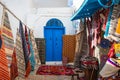 Traditional Tunesian carpets hanging on blue walls in resort town Sidi Bou Said. Tunisia, North Africa