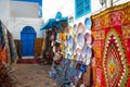 Traditional Tunesian carpets hanging on blue walls in resort town Sidi Bou Said. Tunisia, North Africa