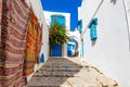 Traditional Tunesian carpets hanging on blue walls in resort town Sidi Bou Said. Tunisia, North Africa Royalty Free Stock Photo