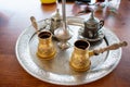 Traditional Tunisian Coffee, Closeup of ornamental decorative silver and gold cup and saucer with tea or coffee Royalty Free Stock Photo