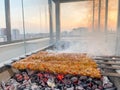 Traditional Turkish Adana Kebap on the grill with skewers for dinner. Turkish cuisine food culture in Turkey. Royalty Free Stock Photo