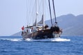 Traditional Turkish Boat or Gulet cruising at sea. Touristic Sail Boats near the beach of Bodrum, Aegean Turkey.