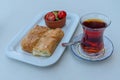 Traditional Turkish breakfast, tea, water pastry and tomato, cucumber