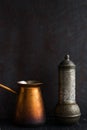 Traditional Turkish coffee and concept. Copper coffee pot. Cezve, vintage coffee grinder on a dark background Royalty Free Stock Photo