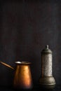 Traditional Turkish coffee and concept. Copper coffee pot. Cezve, vintage coffee grinder on a dark background Royalty Free Stock Photo