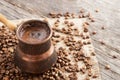 Traditional turkish coffee in copper coffee pot on coffee beans Royalty Free Stock Photo