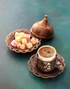 Traditional turkish coffee and turkish delight on dark green wooden background Royalty Free Stock Photo