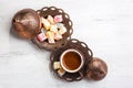 Traditional turkish coffee and turkish delight on white shabby wooden background. Top view