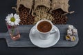 Traditional turkish coffee drink concept. Turkish coffee with glass of water and turkish delights on wooden table Royalty Free Stock Photo