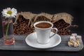 Traditional turkish coffee drink concept. Turkish coffee with glass of water and turkish delights on wooden table Royalty Free Stock Photo