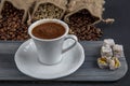 Traditional turkish coffee drink concept. Turkish coffee with glass of water and turkish delights on wooden table Royalty Free Stock Photo