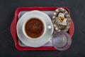 Traditional turkish coffee drink concept. Turkish coffee with glass of water and turkish delights on wooden table Royalty Free Stock Photo