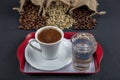 Traditional turkish coffee drink concept. Turkish coffee with glass of water and turkish delights on wooden table Royalty Free Stock Photo