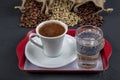 Traditional turkish coffee drink concept. Turkish coffee with glass of water and turkish delights on wooden table Royalty Free Stock Photo