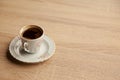 Traditional turkish coffee in patterned white cup on oak coffee table Royalty Free Stock Photo