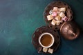 Traditional turkish coffee and turkish delight on dark green wooden background. flat lay Royalty Free Stock Photo