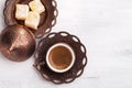 Traditional turkish coffee and turkish delight on white shabby wooden background. flat lay