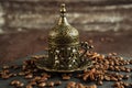 Traditional turkish coffee in vintage cup, anise, roasted beans on brown background 1 Royalty Free Stock Photo