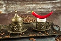 Traditional turkish coffee in vintage cup, anise, roasted beans with hot spicy chili pepper on brown background 8 Royalty Free Stock Photo