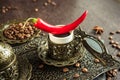 Traditional turkish coffee in vintage cup, anise, roasted beans with hot spicy chili pepper on brown background 10 Royalty Free Stock Photo