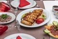 Traditional Turkish Cuisine, Grilled chicken wings baking on wooden background, top view Royalty Free Stock Photo