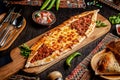 Traditional Turkish cuisine. Turkish pizza Pita with a different stuffing, meat, cheese, slices of veal. Turk Pidesi or Sucuk Pide