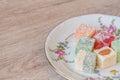 Traditional turkish delight on a plate on white wooden background. Assorted Oriental sweets. Top view Royalty Free Stock Photo