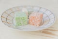 Traditional turkish delight on a plate on white wooden background. Assorted Oriental sweets Royalty Free Stock Photo