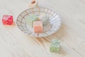 Traditional turkish delight on a plate on white wooden background. Assorted Oriental sweets Royalty Free Stock Photo