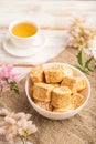 Traditional turkish delight rahat lokum with cup of green tea on a white wooden background. side view, close up Royalty Free Stock Photo