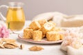 Traditional turkish delight rahat lokum with glass of green tea on a gray concrete background, side view, selective focus Royalty Free Stock Photo