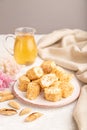 Traditional turkish delight rahat lokum with glass of green tea on a gray concrete background, side view, selective focus Royalty Free Stock Photo