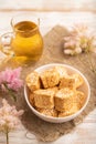 Traditional turkish delight rahat lokum with glass of green tea on a white wooden background. side view, close up Royalty Free Stock Photo