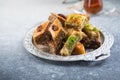 Traditional Turkish Desserts Baklava with  Tea. Crispy mix baklava on silver  plate Royalty Free Stock Photo