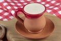 Traditional Turkish Dibek coffee in coffee cup on wooden table. Turkish dibek coffee grinded in a large stone mortar with the