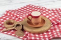 Traditional Turkish Dibek coffee in coffee cup on wooden table. Turkish dibek coffee grinded in a large stone mortar with the