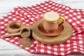 Traditional Turkish Dibek coffee in coffee cup on wooden table. Turkish dibek coffee grinded in a large stone mortar with the