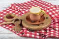 Traditional Turkish Dibek coffee in coffee cup on wooden table. Turkish dibek coffee grinded in a large stone mortar with the