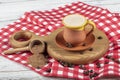 Traditional Turkish Dibek coffee in coffee cup on wooden table. Turkish dibek coffee grinded in a large stone mortar with the