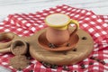 Traditional Turkish Dibek coffee in coffee cup on wooden table. Turkish dibek coffee grinded in a large stone mortar with the