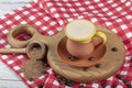 Traditional Turkish Dibek coffee in coffee cup on wooden table. Turkish dibek coffee grinded in a large stone mortar with the Royalty Free Stock Photo