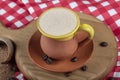 Traditional Turkish Dibek coffee in coffee cup on wooden table. Turkish dibek coffee grinded in a large stone mortar with the