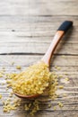 Traditional Turkish dry raw bulgur cereal in a wooden spoon Royalty Free Stock Photo
