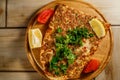 Traditional Turkish food Lahmajun on a wooden tray. Royalty Free Stock Photo