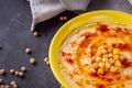 Traditional turkish hummus on a dark stone background