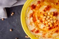 Traditional turkish hummus on a dark stone background