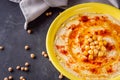 Traditional turkish hummus on a dark stone background