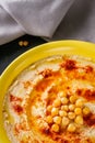 Traditional turkish hummus on a dark stone background