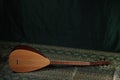 Traditional Turkish national musical instrument baglama saz on a dark green background. a magnificent century. The concept of